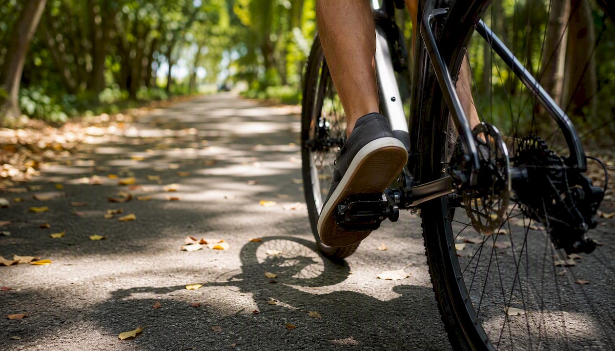 Best Bike Routes in Boca Raton: Your Complete Riding Guide 2 Cyclist feet and trail surface in shaded Boca Raton path
