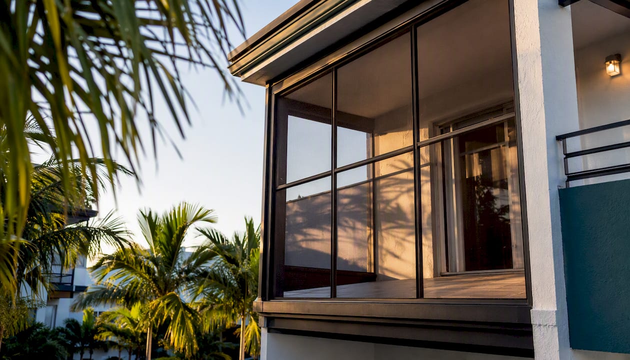 Screened balcony catio on apartment exterior
