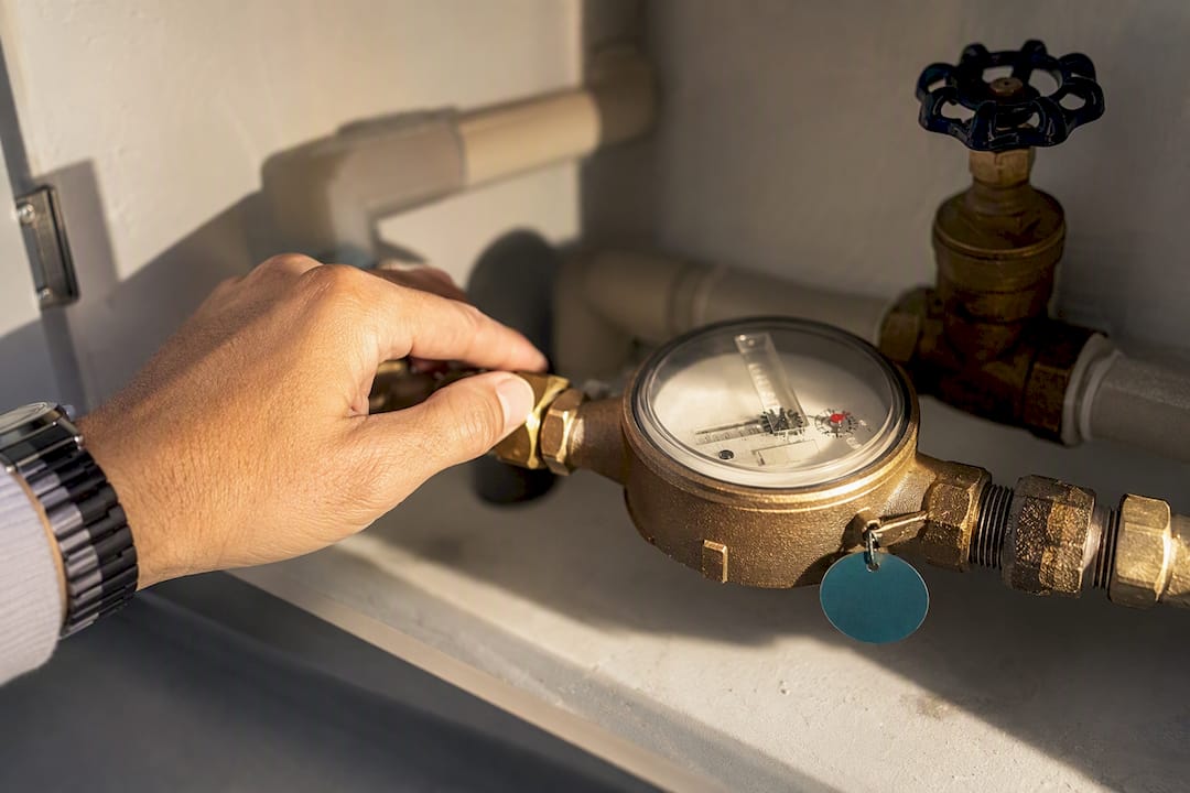Renter checking an apartment water meter