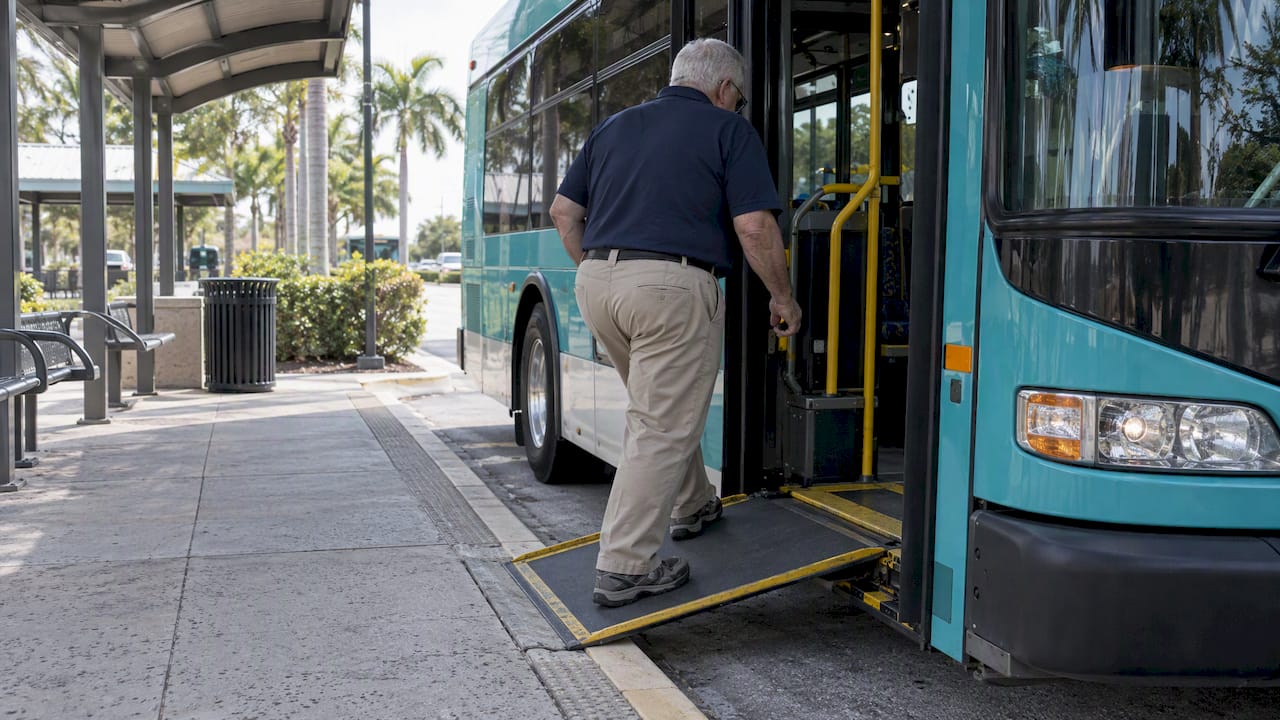 Rider using Palm Tran bus access ramp