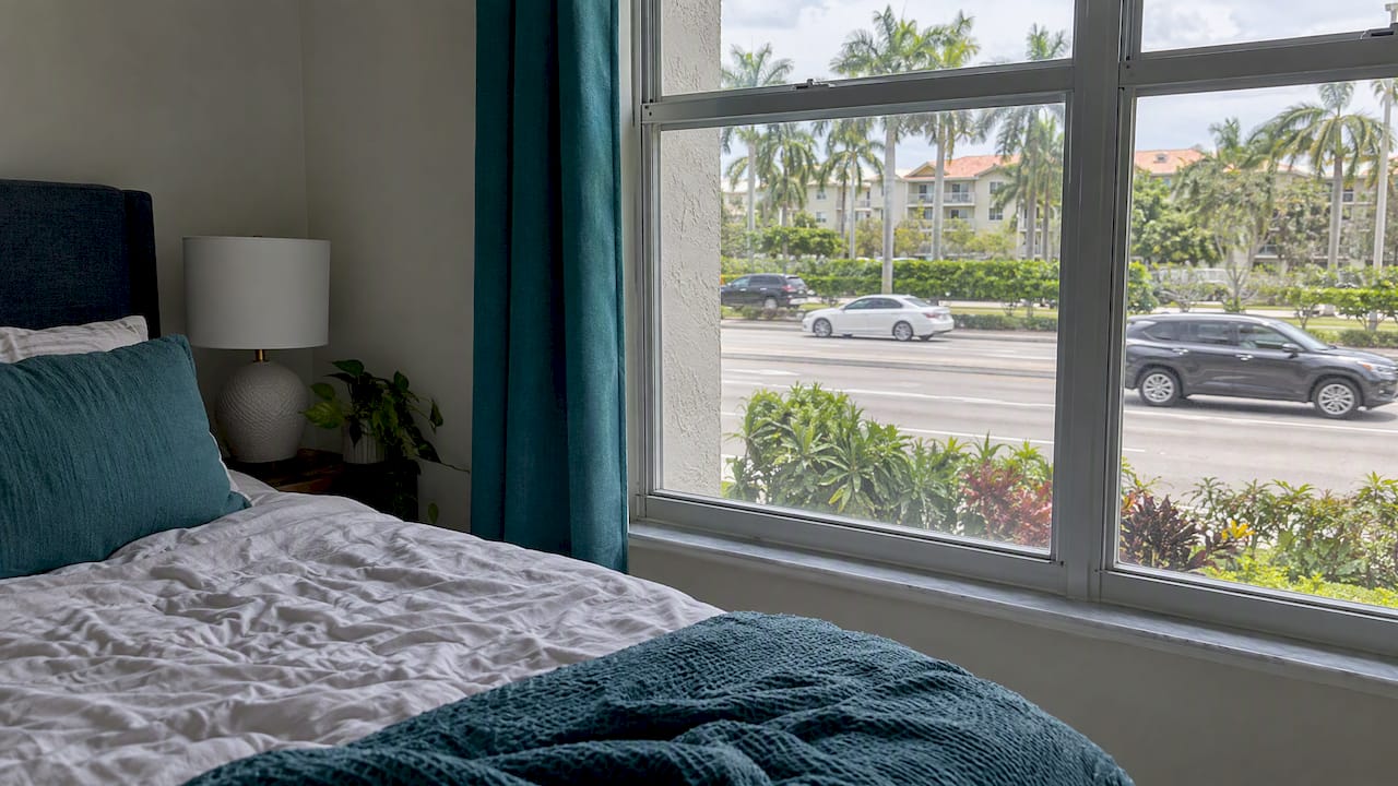 Apartment bedroom window facing passing road traffic